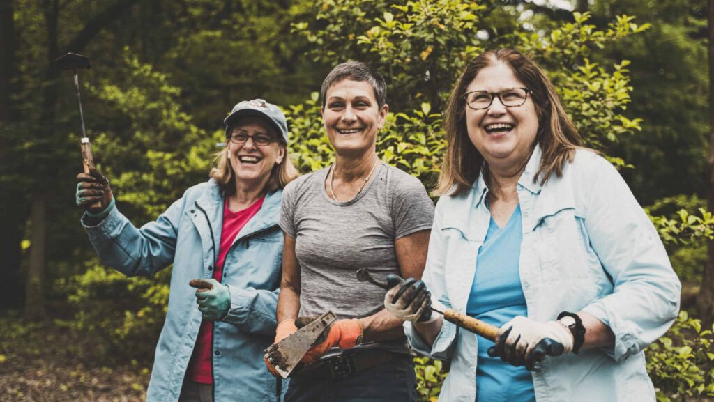 A smiling group of three female volunteers