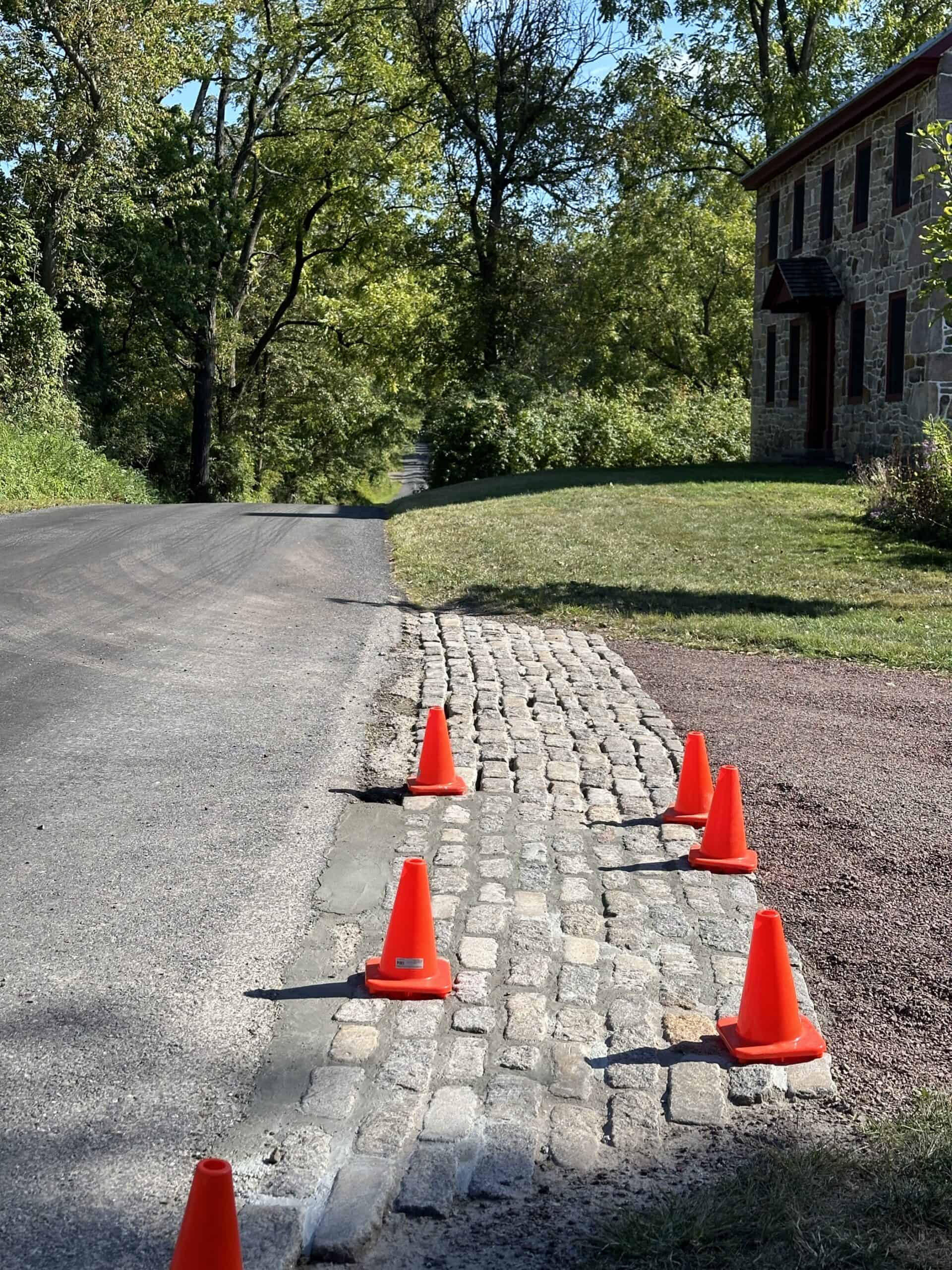 Cobblestone driveway entrance being repointed.