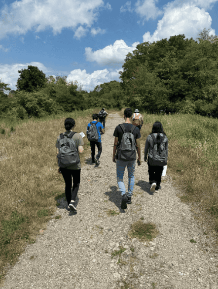 A group of youth walking down a gravel path at Willisbrook Preserve.