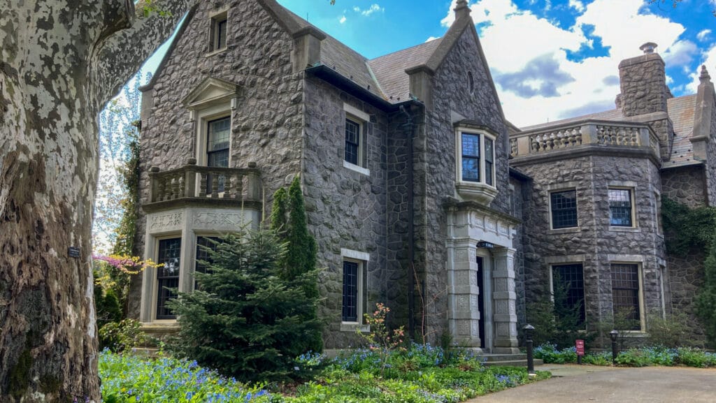 photo of mansion surrounded by blooming gardens