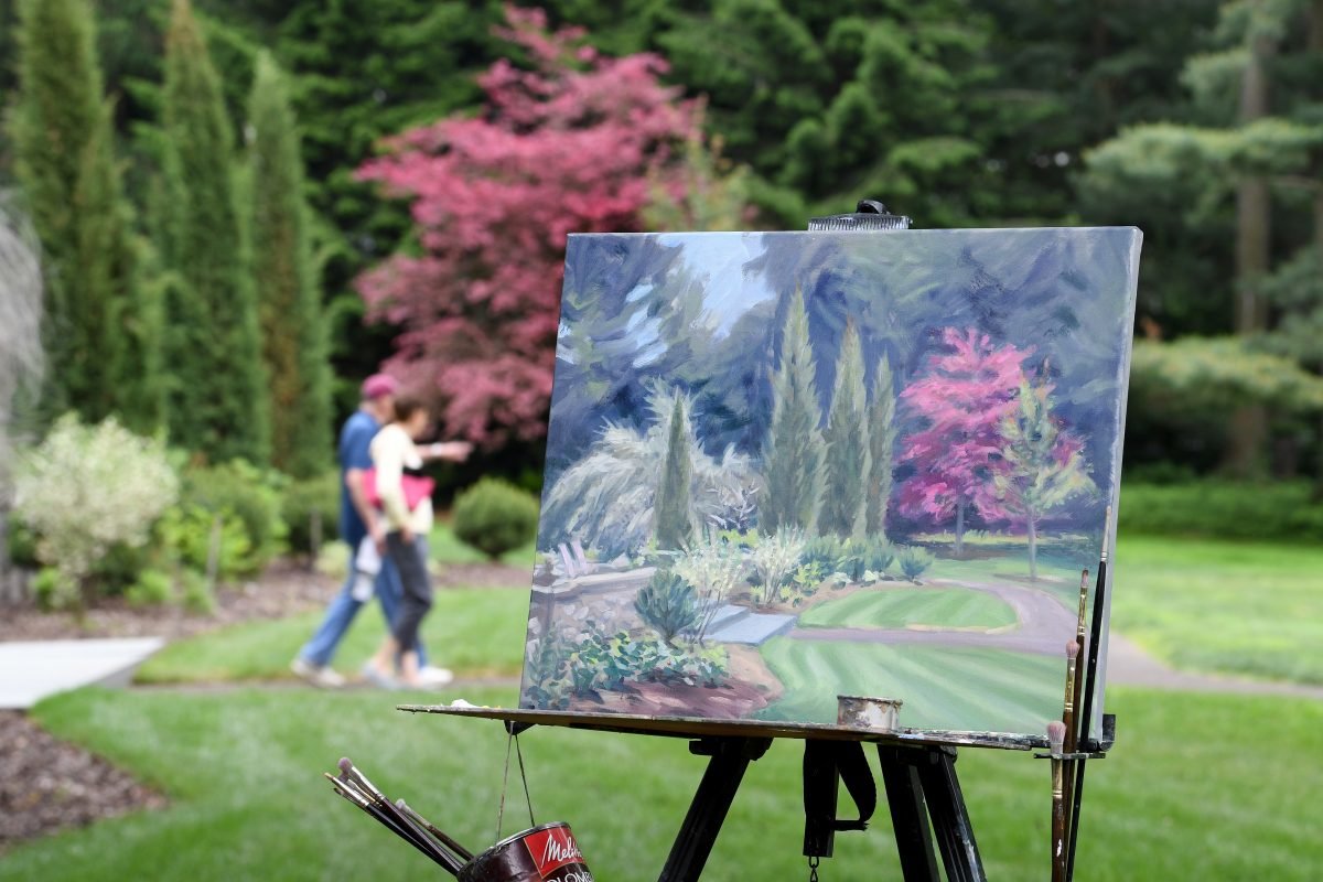 A painting in process outdoors in a garden.