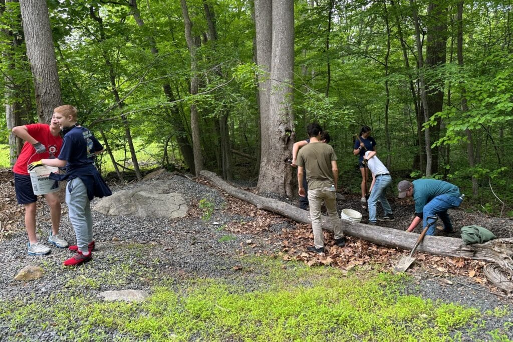 Cadets forming a bucket brigade to move gravel.