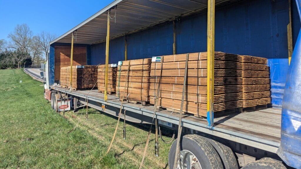 A tractor trailer loaded with wooden stakes for a tree seedling planting