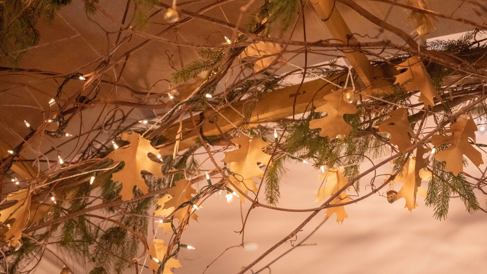twigs, oak leaves, and evergreen garland as holiday decor