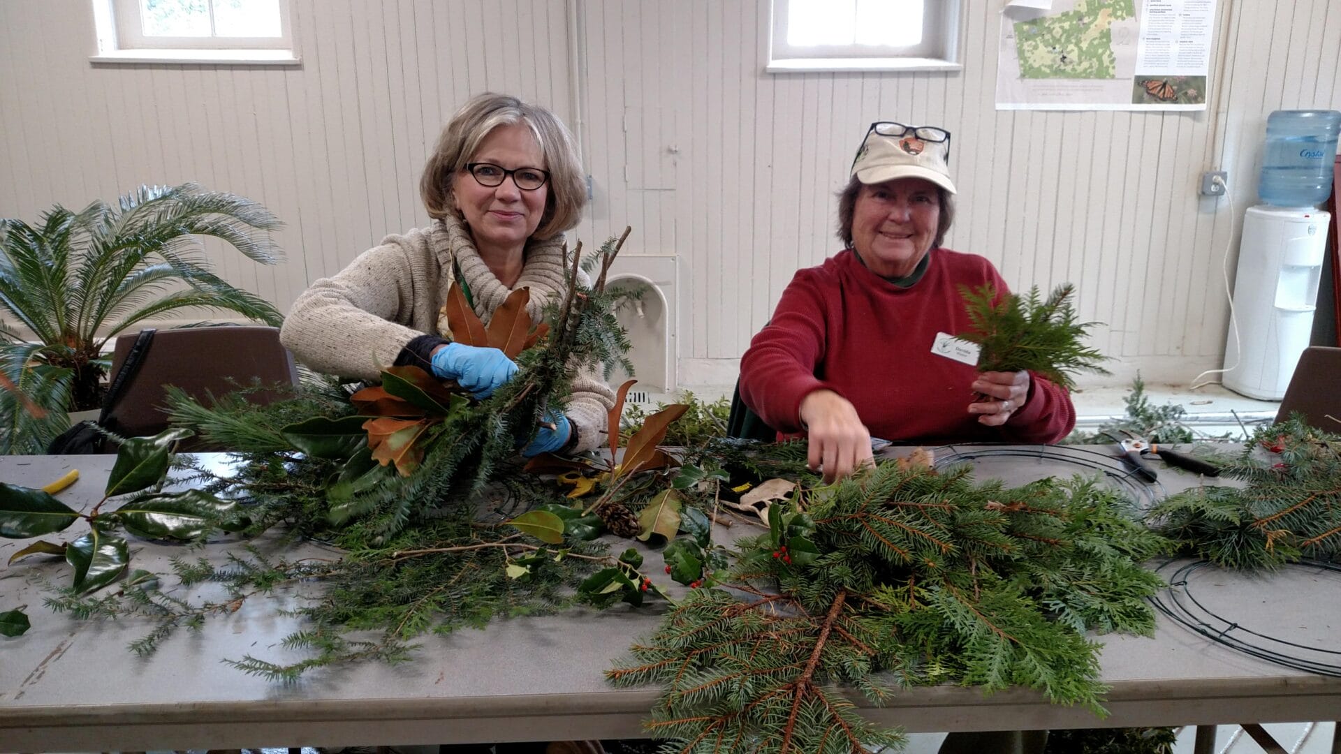 two volunteers working on natural holiday decor