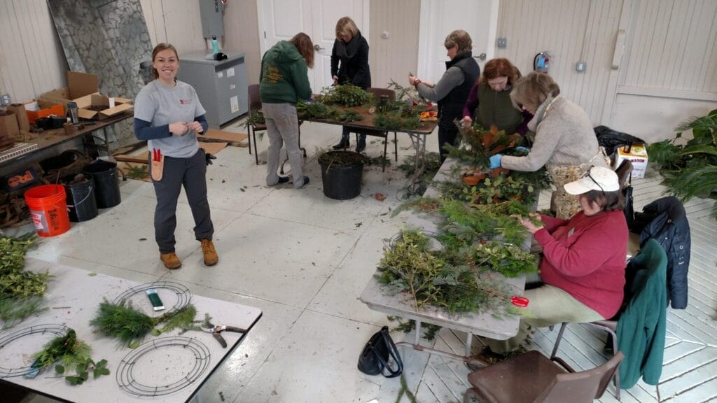 volunteers working on natural holiday decor