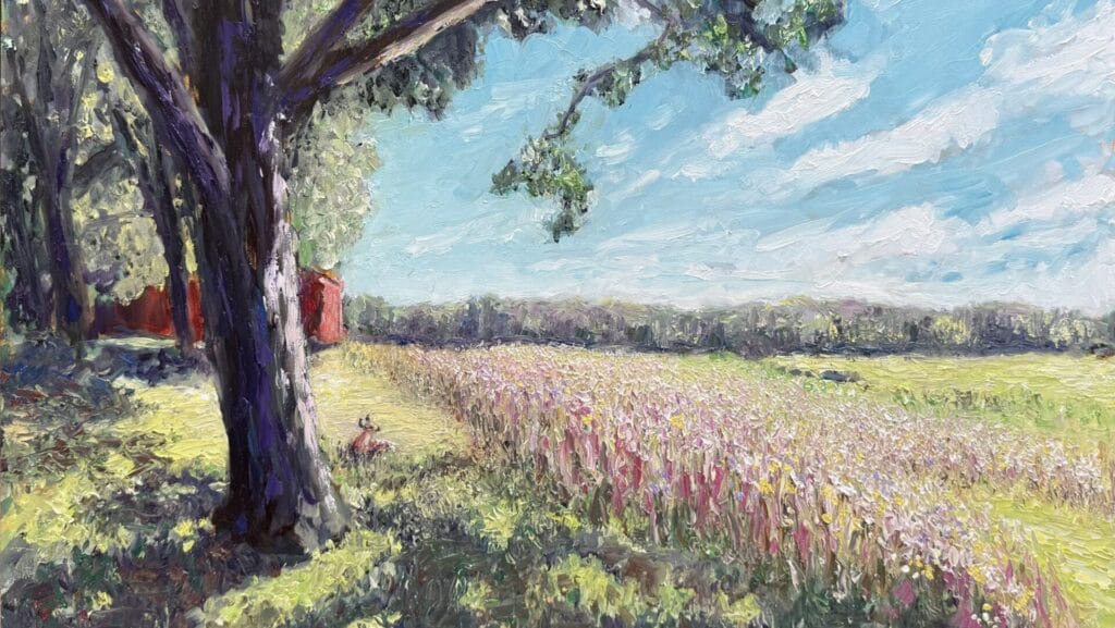 an oil painting of a tree and meadow with a deer lying in the grass, a red barn, and blue sky