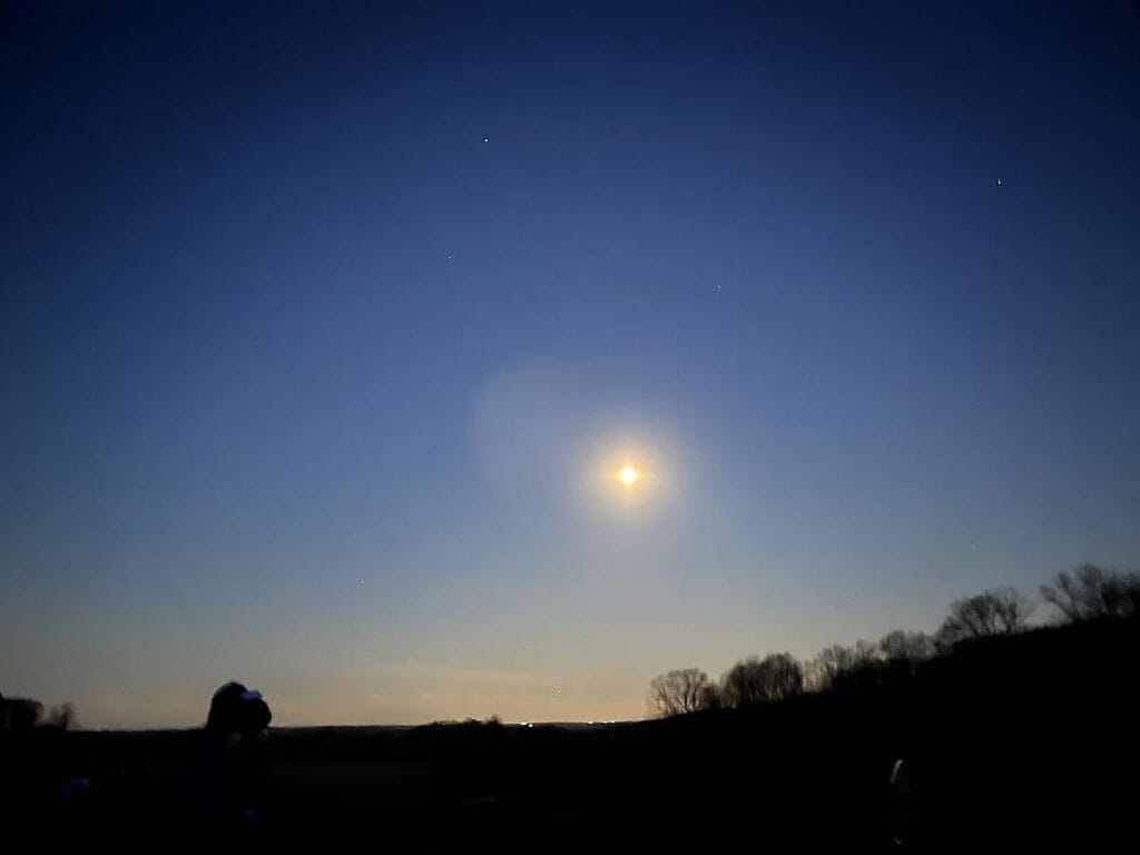 a full moon over winter fields