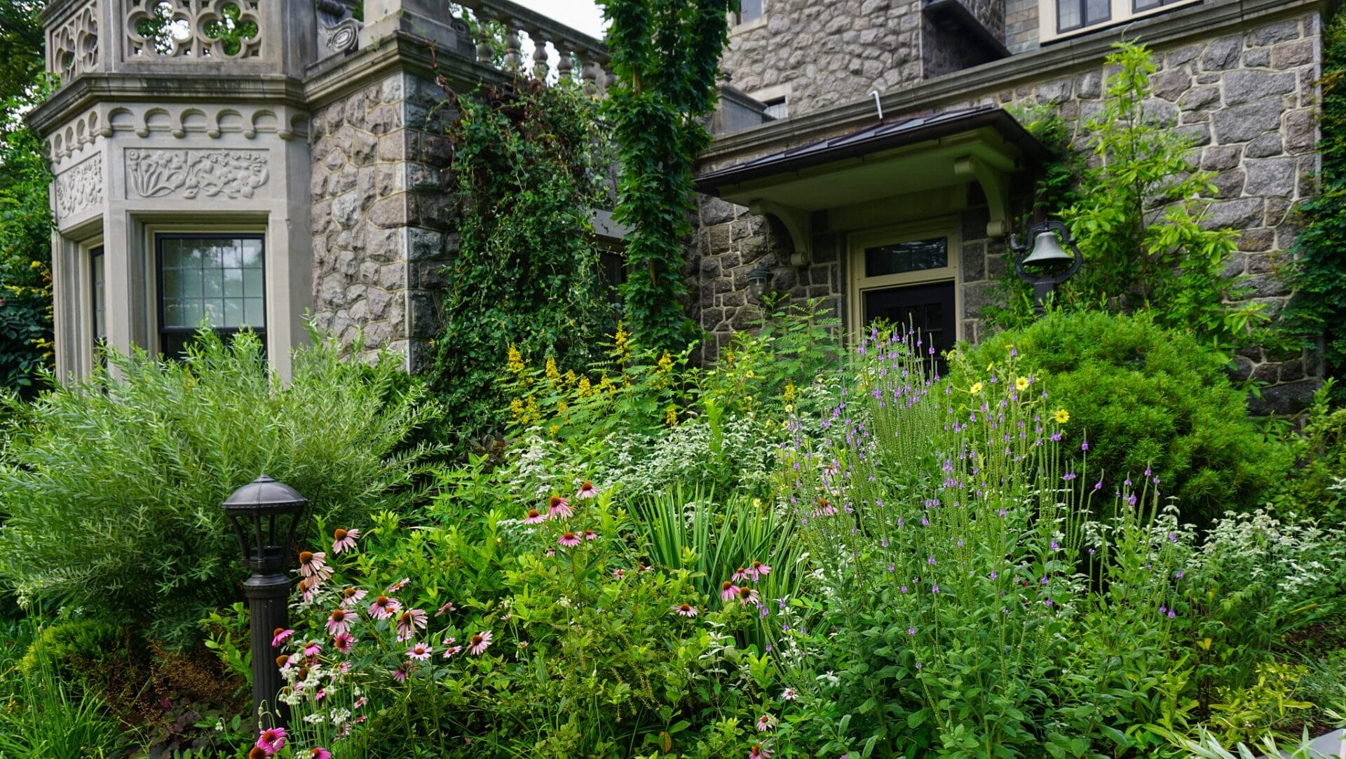 Stone house surrounded by blooming garden