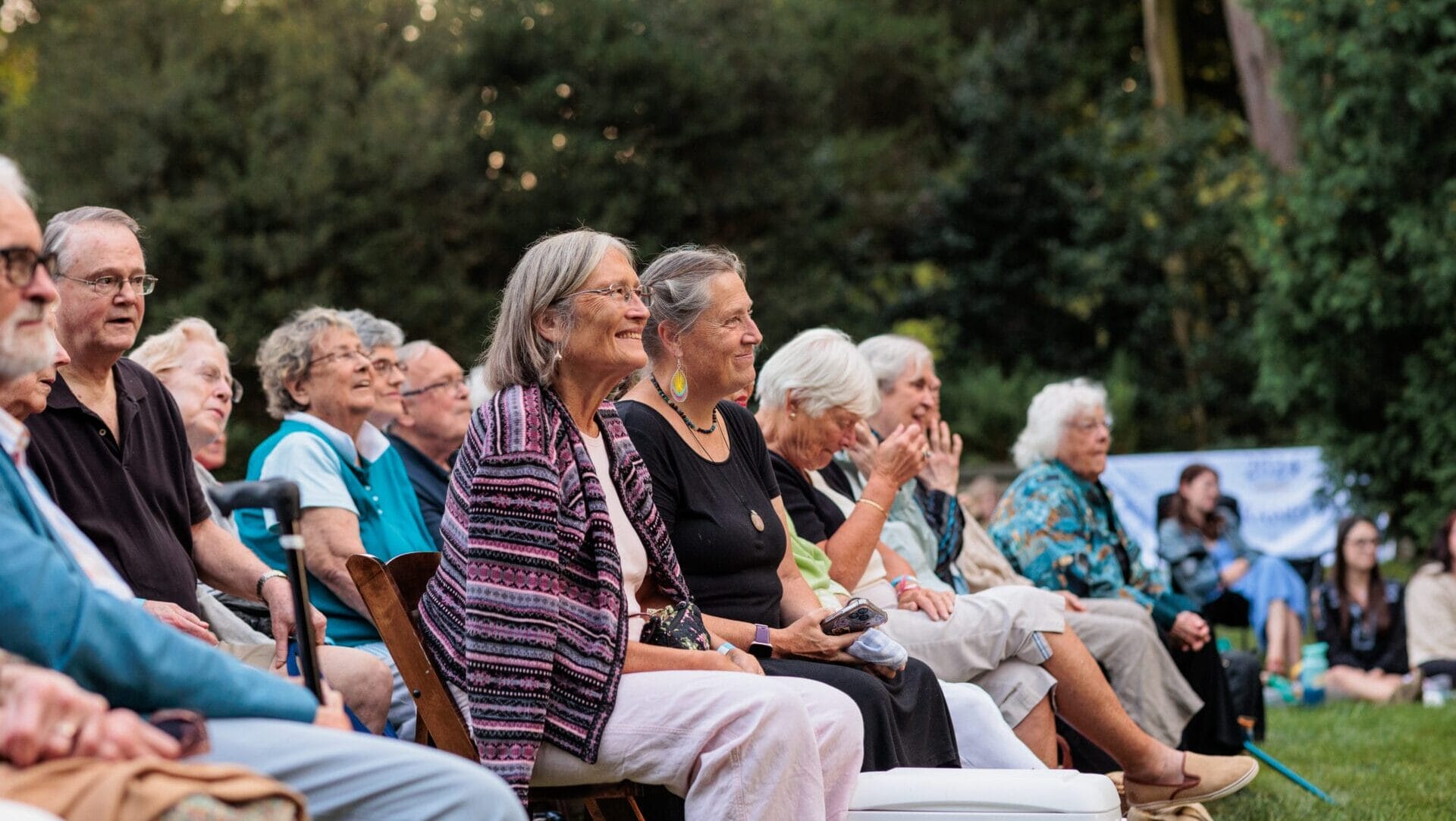 an audience sitting in a garden