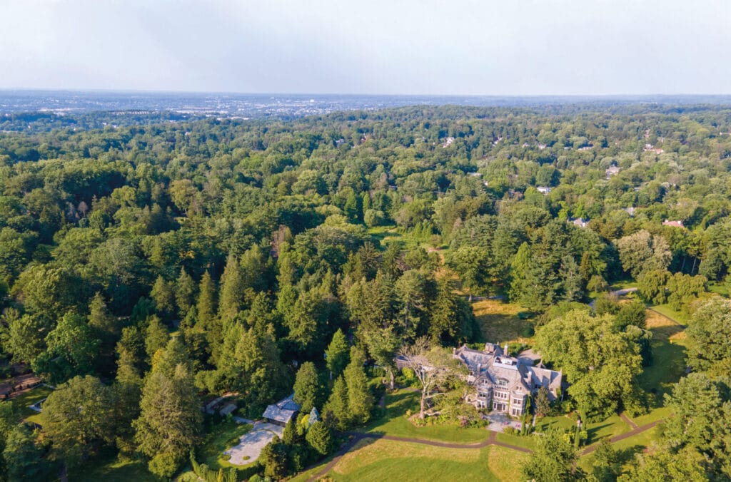 a bird's eye view of a stone house surrounded by trees