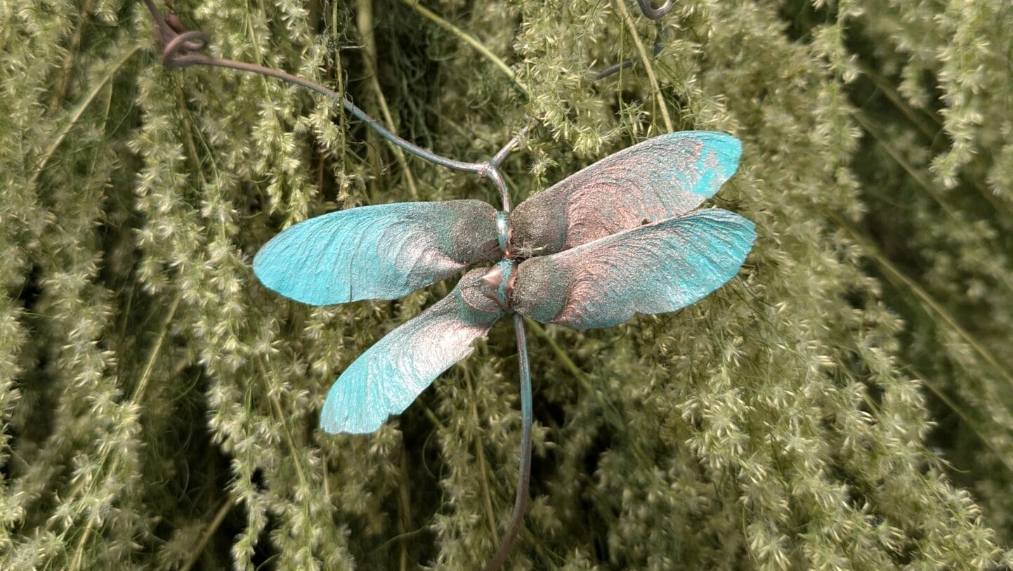 A dragonfly made of dried plant materials.