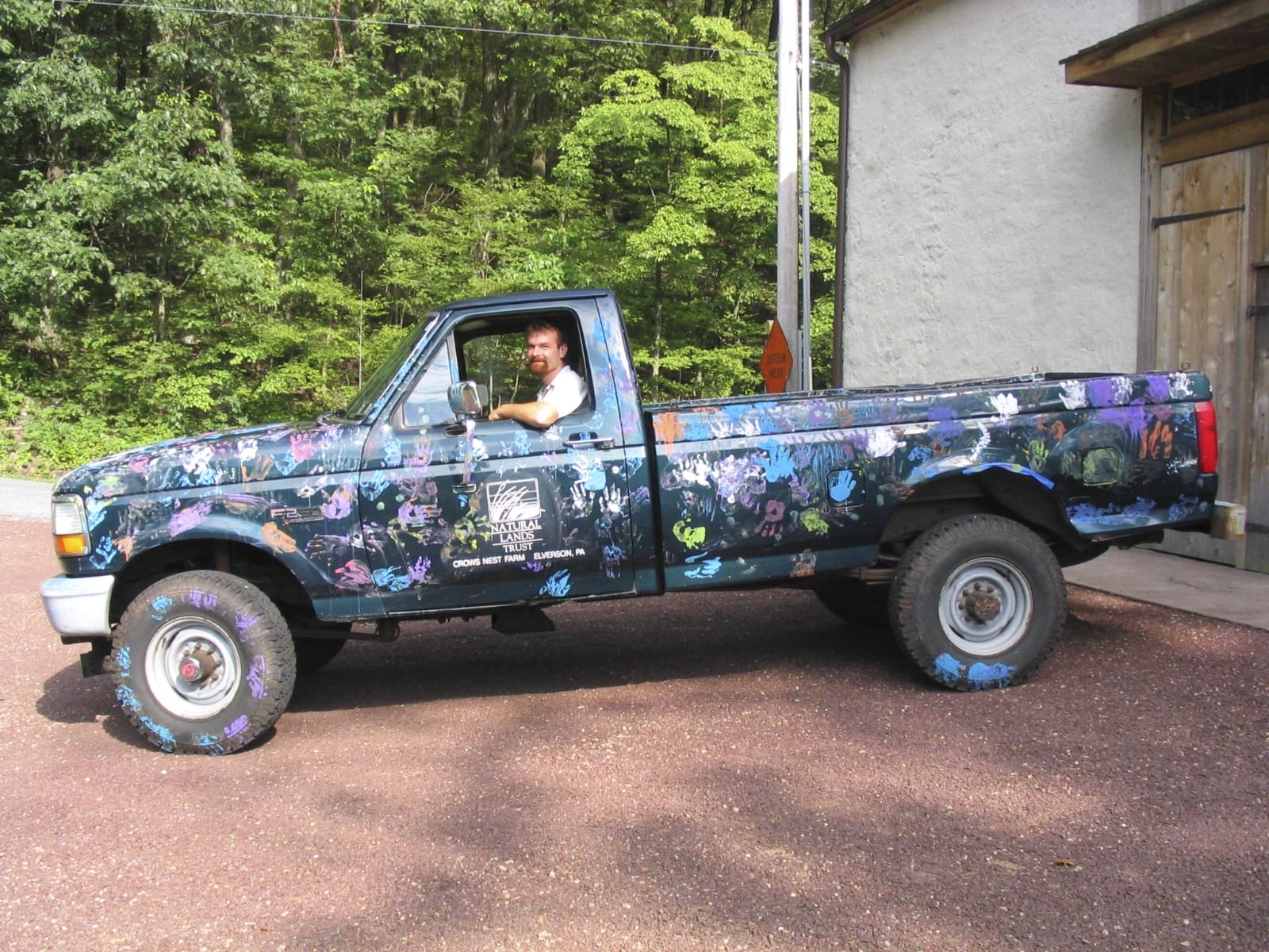 A pickup truck covered with painted hand prints